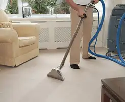 Carpet cleaning professional removing dirt and stains with a hot-water extraction tool in a home, Reno, NV.